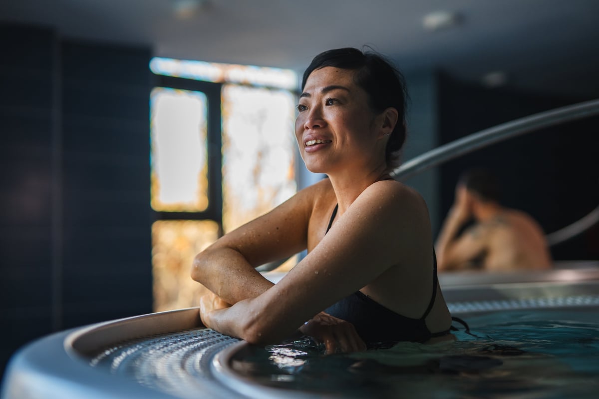 Woman relaxing in a freestanding whirlpool bathtub